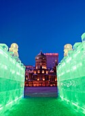 Saint Sophia church at night viewed from illuminated ice sculpture during annual ice lantern festival in Harbin China