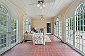 Porch in suburban home with red brick floor