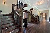 Foyer in new construction home with dark wood stairway