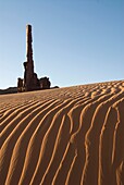 Early morning view of the Totem Pole with sand dunes in the foreground, Monument Valley Navajo Tribal Park, Arizona, USA