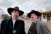 Tombstone, Arizona - Actors portray the wild west lawman, Virgil Earp left and his sidekick, John ´Doc´ Holliday on streets of Tombstone  The OK Corral is in the background