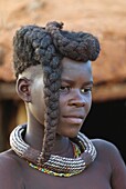 Himba woman with the typical double plait hairstyle, Kaokoland, Namibia