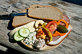 Typical snack of assorted cheese, ham, salami and bread, Loosegg Alm, Salzburger Land, Austria