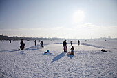 Persons on frozen outer Alster in winter, Hamburg, Germany