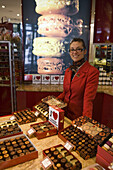 Smiling shop assistant at Les Caneles Baillardran bakery and cake shop, Bordeaux, Gironde, Aquitane, France, Europe