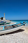 Fishing boats at the beach of Fins. Mosque and minaret of the village Fins in the background, Arabian Sea, Sultanate of Oman, Asia.