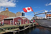 boat with flying Canadian Flag mooring at the Harbour Walk of Halifax, Nova Scotia, Canada, North America.