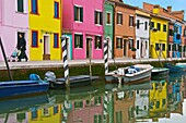 coloured houses and boats on canal, the island of Burano Venice Italy