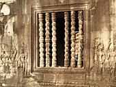Cambodia - Window with colonettes and Devatas deity, divinity in the temple of Angkor Wat The temple complexes of Angkorcity,  were the heart of the Khmer empire which flourished from the 9th to the 13th century and today are a UNESCO World Heritage Sit