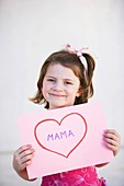 brown hair, card, Caucasian ethnicity, chestnut hair, child, childhood, clipping path, Color image, contemporary, daughter, Female, girl, happiness, happy, headshot, heart, holding, human, idea, infancy, innocence, innocent, joy, kid, looking at camera, l