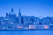 Malta, Valletta, city view with St Paul's Anglican Cathedral and Carmelite Church from Sliema, dusk