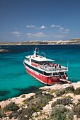 Malta, Comino Island, The Blue Lagoon with tour boat