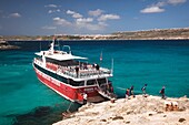 Malta, Comino Island, The Blue Lagoon with tour boat