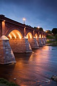 Latvia, Western Latvia, Kurzeme Region, Kuldiga, bridge over the Venta River by the Ventas Rumba, Kuldiga Waterfall, Europe's widest falls, width 275 meters, evening