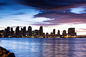 Waterfront city view with USS Midway aircraft carrier from Harbor Island at dawn, San Diego, California, USA