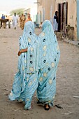 Young girls walking in the street, Atar town, Sahara desert, Mauritania