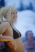 Woman bathing in outdoor pool, Four Seasons Resort Whistler, Whistler, British Columbia, Canada