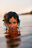 Woman bathing in lake Starnberg, Ambach, Munsing, Bavaria, Germany