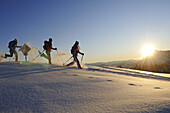 People snowshoeing in snowy landscape, Eggenalm, Reit im Winkl, Chiemgau, Upper Bavaria, Bavaria, Germany, Europe