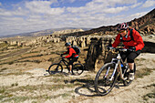 Mountain bikers near  Cavusim, Göreme valley, Göreme, Cappadocia, Turkey