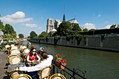 Café on Peniche on River Seine in front of Notre Dame Cathedral, Paris, France