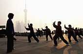 Early morning tai chi exercises on the Bund, Shanghai, China