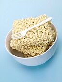 Dry instant noodles isolated against a blue background