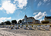 Roofed wicker beach chairs on sandy beach, Kuehlungsborn, Mecklenburg-Vorpommern, Germany