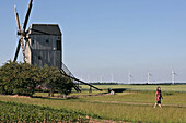 Woman Walking Near The Wind Turbines And The Levesville La Chenard Windmill, Wind Park Of The Beauce, Eure-Et-Loir (28), France