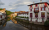 Houses at river Nive in the evening, Saint-Jean-Pied-de Port, Pyrenees Atlantiques, Aquitaine, France