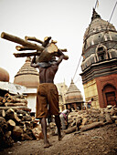 Men carrying firewood for a cremation ceremony, Manikarnika ghat, Varanasi, Uttar Pradesh, India