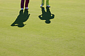 Two men on golf course, Prien am Chiemsee, Bavaria, Germany