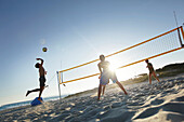 Men playing beach volleyball, Formentera, Balearic Islands, Spain