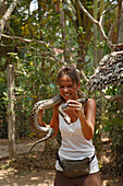Woman holding snake, Mekong, Vietnam