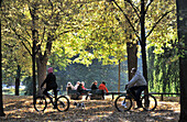 People beneath trees at Luitpoldpark, Schwabing, Munich, Bavaria, Germany, Europe