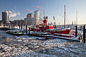 Fire ship in front of HTC Hanseatic Trade Center and Elbphilharmonie in winter, the Free and Hanseatic City of Hamburg, Germany, Europe