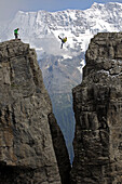 Man hanging on a highline between two rocks, Schilthorn, Bernese Oberland, Canton of Bern, Switzerland