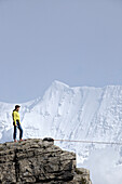 Man standing on a rock with highline, Schilthorn, Bernese Oberland, Canton of Bern, Switzerland