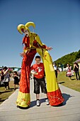 A jester harlequin stilt walker at the The Urdd National Eisteddfod 2010, Llanerchaeron Ceredigion Wales UK