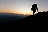 A hiker travels along the Appalachian Trail at sunset near Moun Washington in the White Mountains, New Hampshire USA Notes: Mount Washington is famous for the highest wind gust ever measured on earth at 231 miles per hour on April 12, 1934