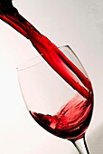Red wine splashing into wine glass