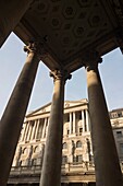 Bank of England on Threadneedle Street viewed throught the columns of The Royal Exchange in the heart of London’s financial district