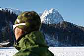 Mount Alpspitze in winter, young man with sunglasses in forground, Garmisch-Partenkirchen, Bavaria, Germany