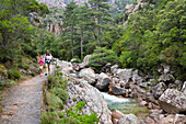 Hiker in the Spelunca Gorges, River Porto near the village of Ota, Corsica, France, Europe