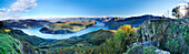 Panorama mit Frau auf Aussichtsbank, Blick auf Luganer See mit Tessiner Alpen, Luganer See, Blick vom Monte San Giorgio, UNESCO Welterbe Monte San Giorgio, Tessin, Schweiz, Europa