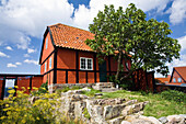 Frame houses under clouded sky, Gudhjem village, Bornholm, Denmark, Europe