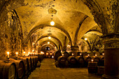 Candlelit barrels inside wine cellar of Eberbach abbey, a medieval monastery at Eltville am Rhein, Rheingau, Hesse, Germany, Europe