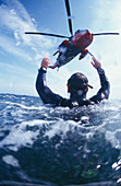 Search and REscue helicopter from Royal Navy Culdrose, Cornwall, England search and rescue diver performing rescue