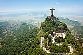 Christ the Redeemer on Corcovado Mountain, Rio de Janeiro Brazil South America The statue stands 38 m 125 feet tall and is located at the peak of the 710-m 2330-foot Corcovado mountain in the Tijuca Forest National Park, overlooking the city As well as b