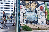 East Side Gallery Brezner and Honecker kissing itself on trabi crossing the wall Berlin Germany